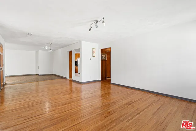a view of a room with wooden floor