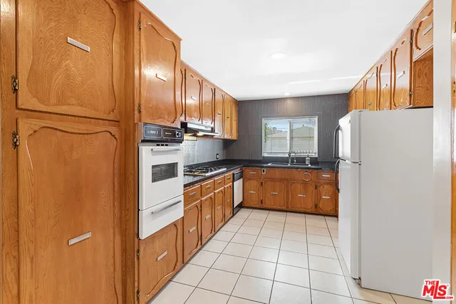a kitchen with stainless steel appliances a refrigerator and a sink