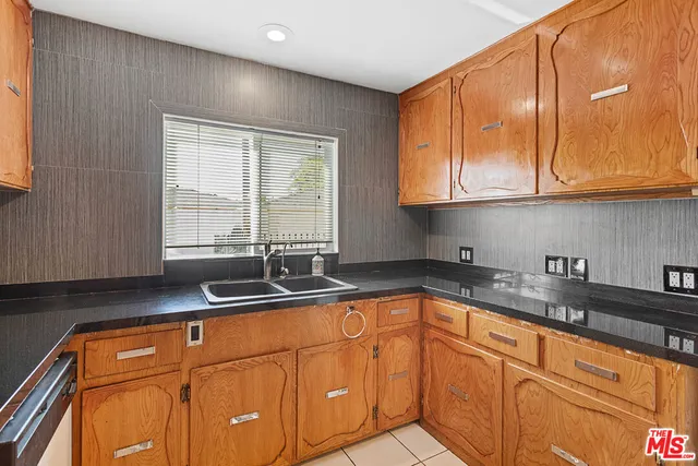 a kitchen with granite countertop cabinets sink and window