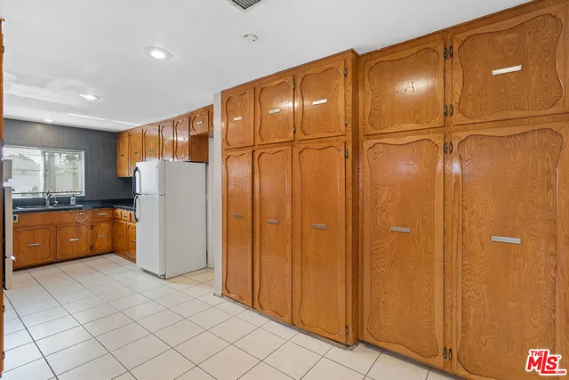 a view of a refrigerator in kitchen and a dishwasher kitchen view