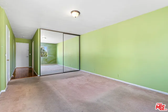 a view of a big room with closet and windows