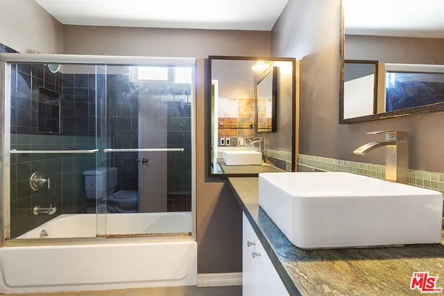 a bathroom with a bathtub and sink