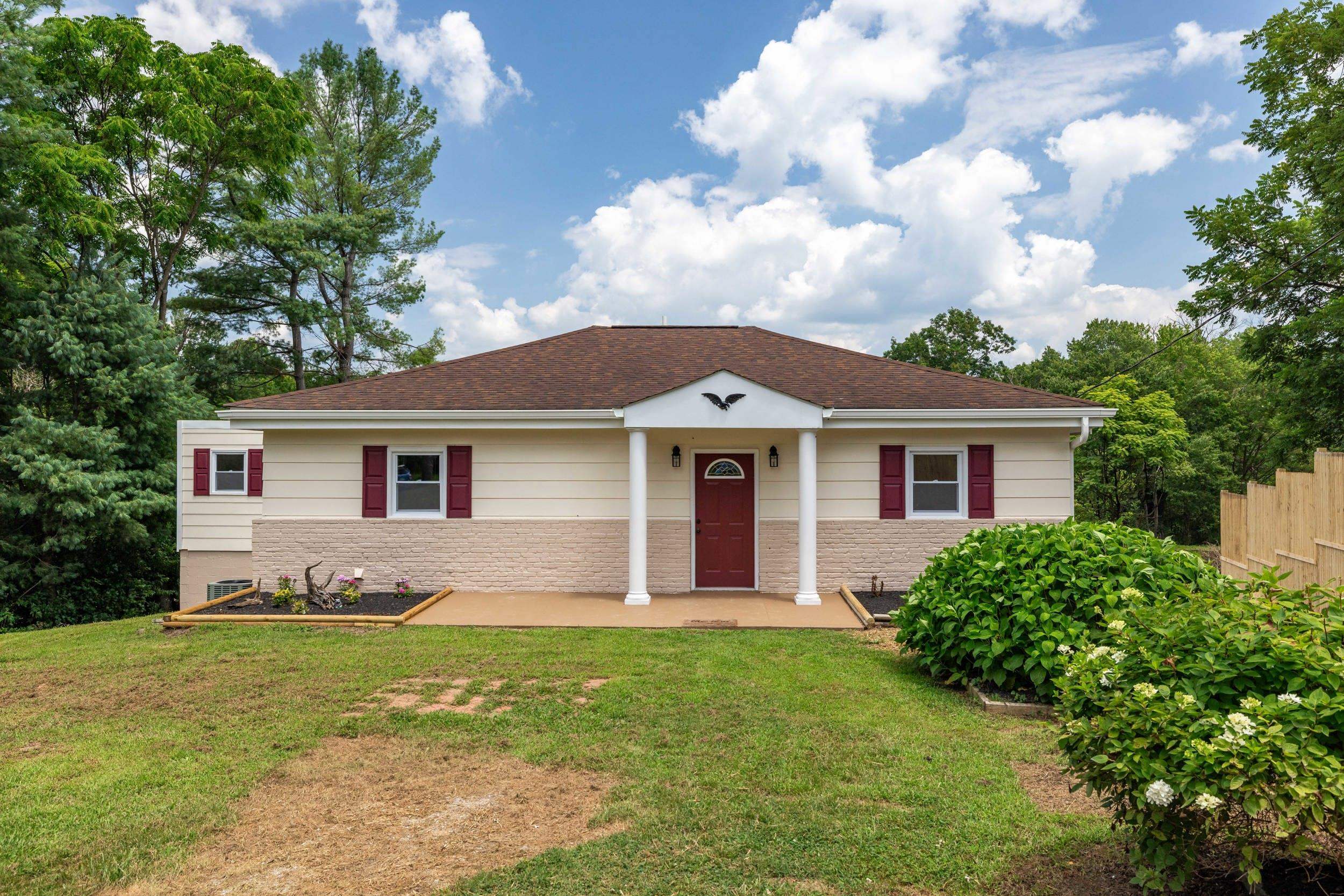 a front view of a house with a garden