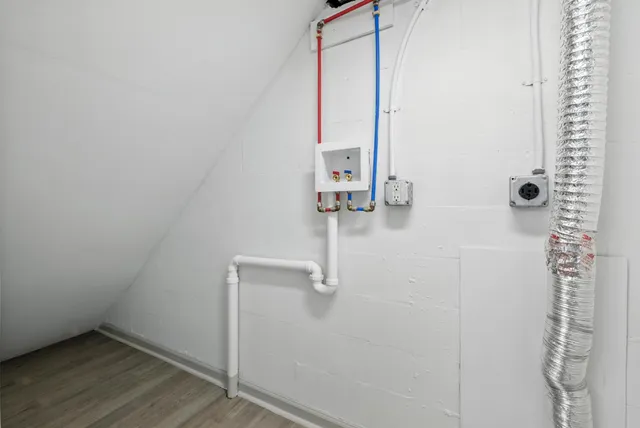 an aerial view of green landscape with trees houses and mountain view