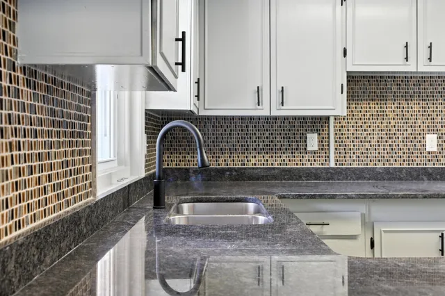 a kitchen with sink and cabinets