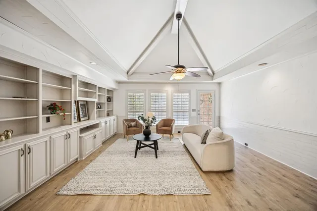 a living room with furniture a rug and white walls