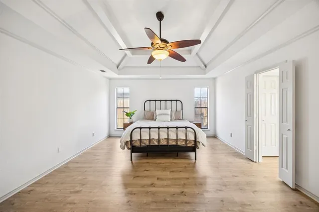 a bedroom with a bed and a chandelier
