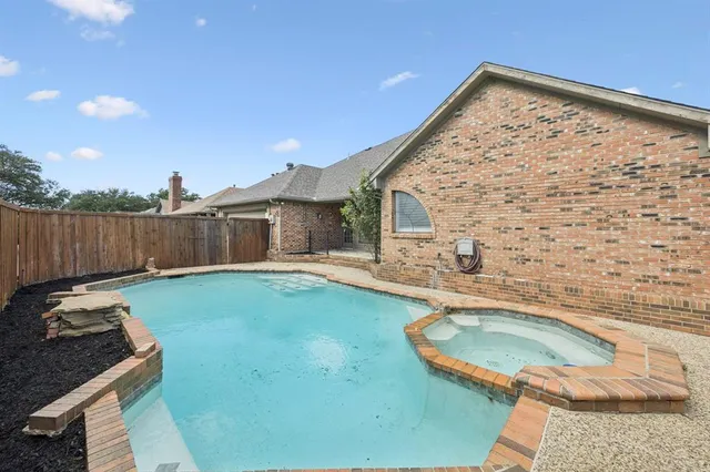 a view of a backyard with swimming pool