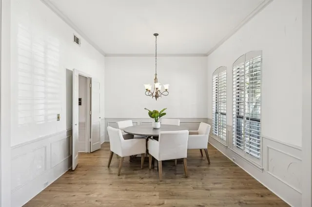 a dining room with furniture a rug and a chandelier