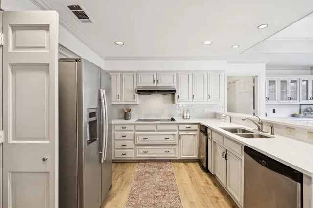 a kitchen with a sink stove and cabinets