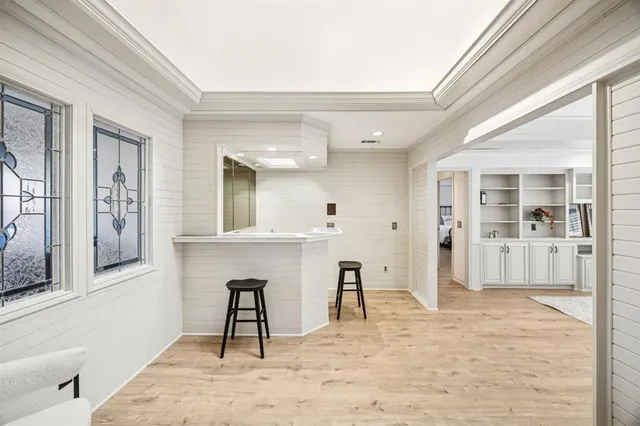 a view of livingroom with wooden floor and a bathroom space