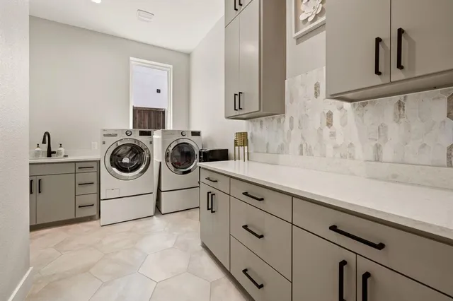a utility room with sink dryer and washer
