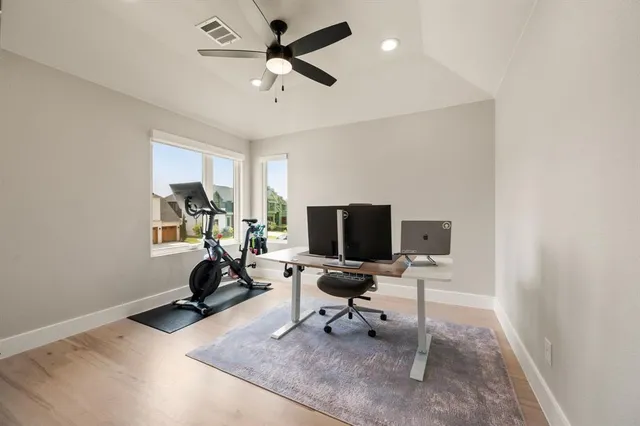 a view of a workspace with furniture and a window