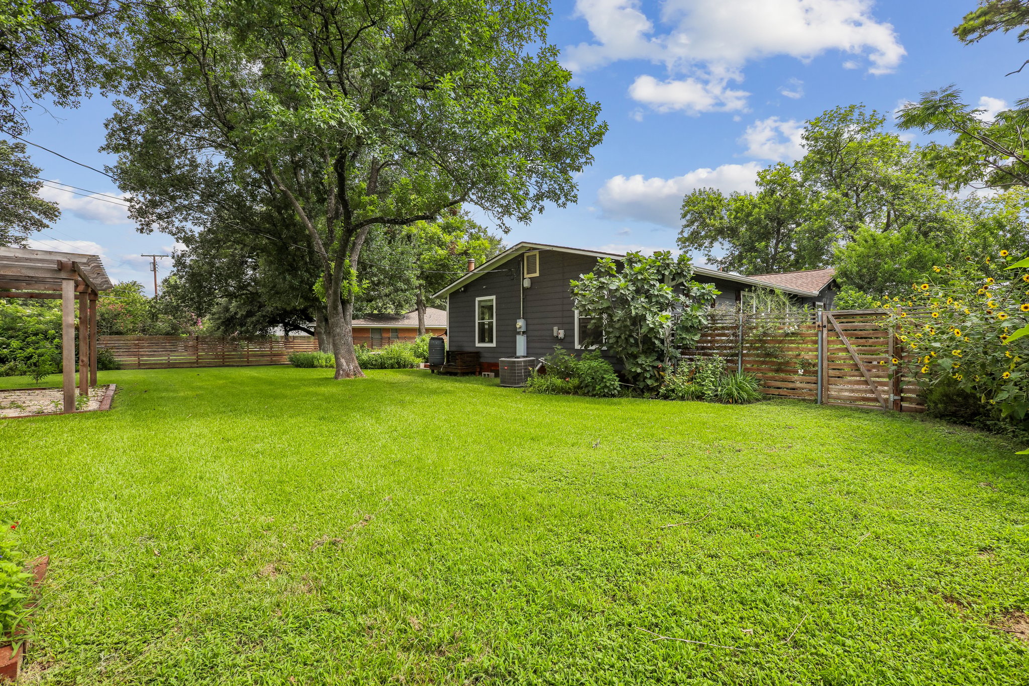 1114 West 2nd Street Elgin, TX 78621 - Photo 27 of 31 A spacious, well-maintained yard provides ample outdoor living space and privacy.