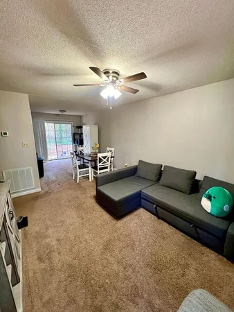 a living room with furniture and wooden floor