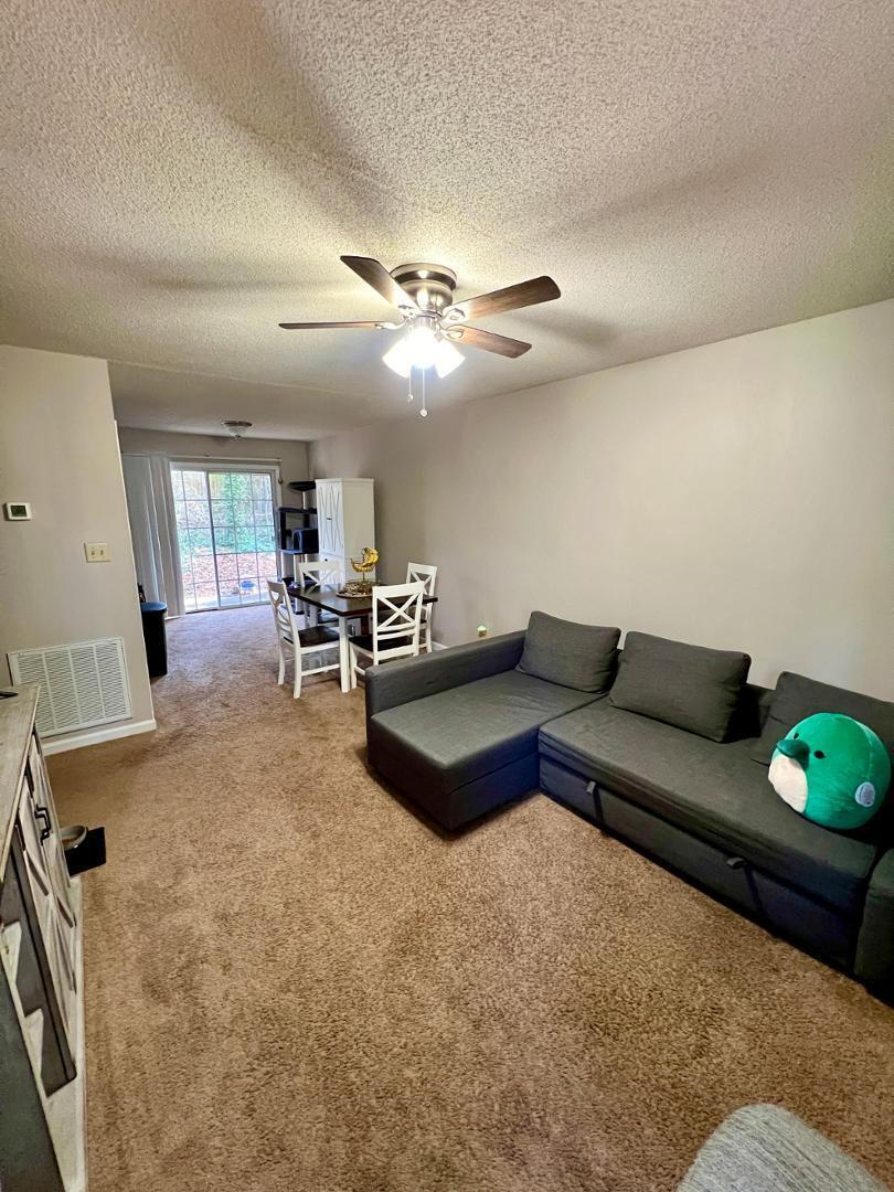 821 Barringer Drive, Unit A Raleigh, NC 27606 - Photo 2 of 8 a living room with furniture and wooden floor