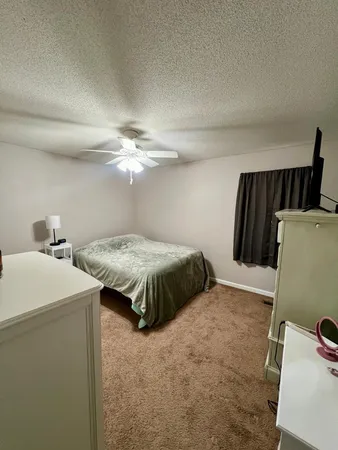 a bedroom with a bed and a large mirror