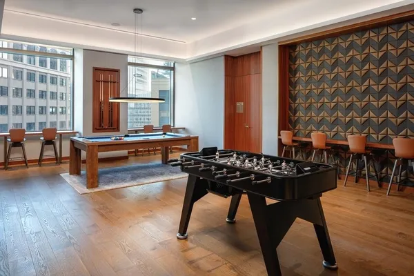 a room with furniture pool table table tennis table and chairs