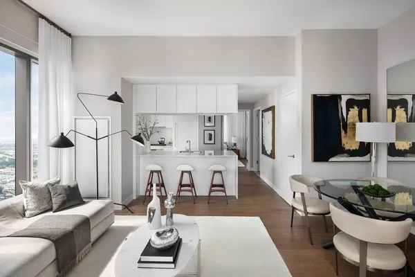 a living room with furniture and a chandelier