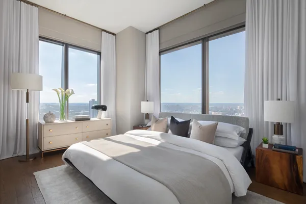 a bedroom with a large bed and a large window