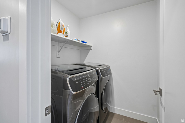 1107 West Wasatch Springs Road, Unit M3 Heber City, UT 84036 - Photo 18 of 34 Dedicated laundry area featuring a built-in shelf, modern appliances, and tiled flooring