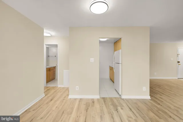 a view of a room with wooden floor and bathroom