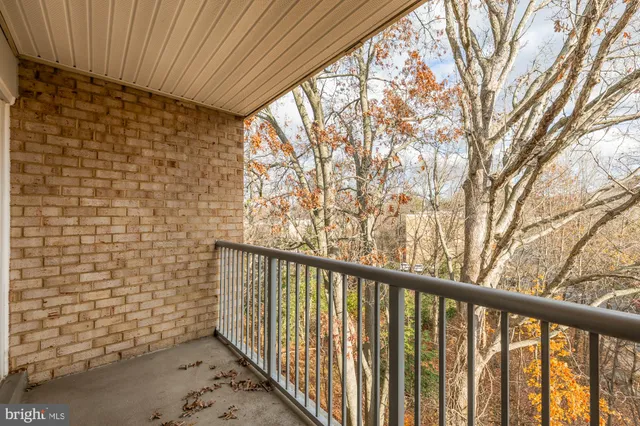 a view of a balcony with yard