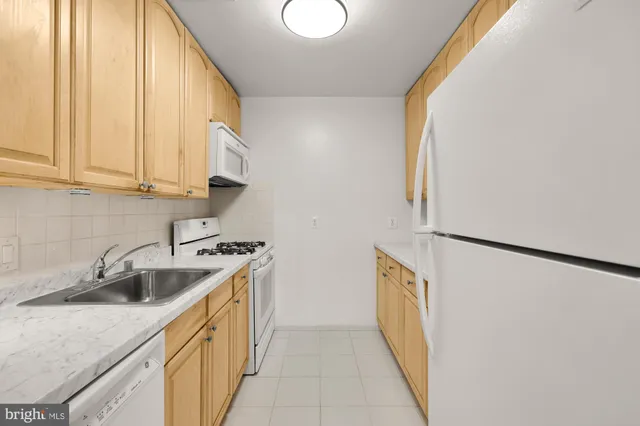 a kitchen with a sink a stove and a refrigerator