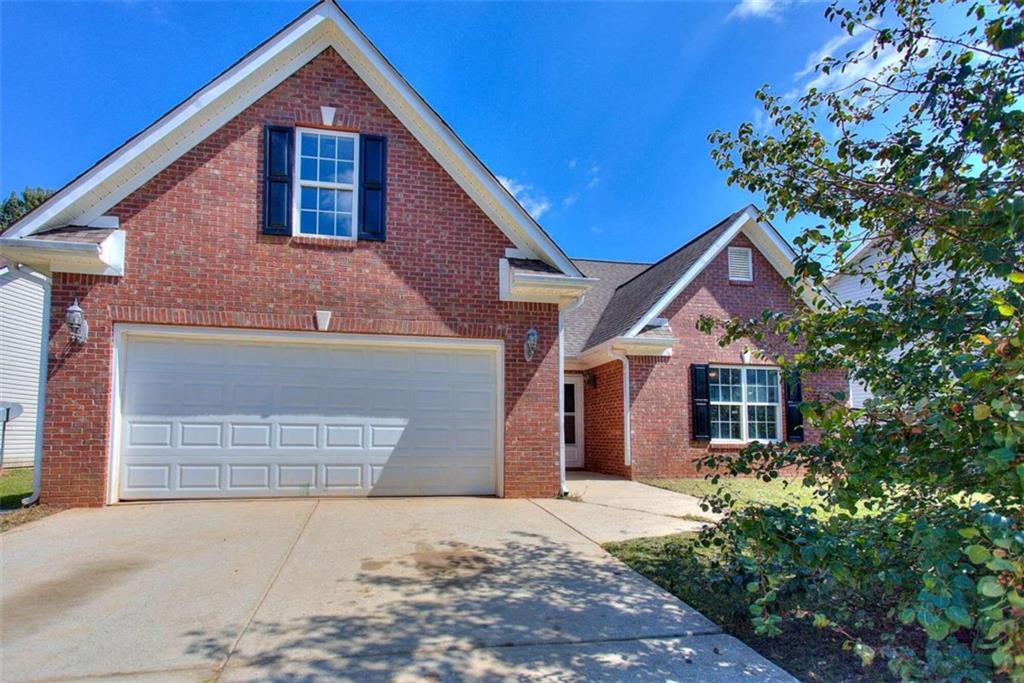 1540 Queen Elizabeth Drive Locust Grove, GA 30248 - Photo 1 of 1 a front view of a house with a yard and garage