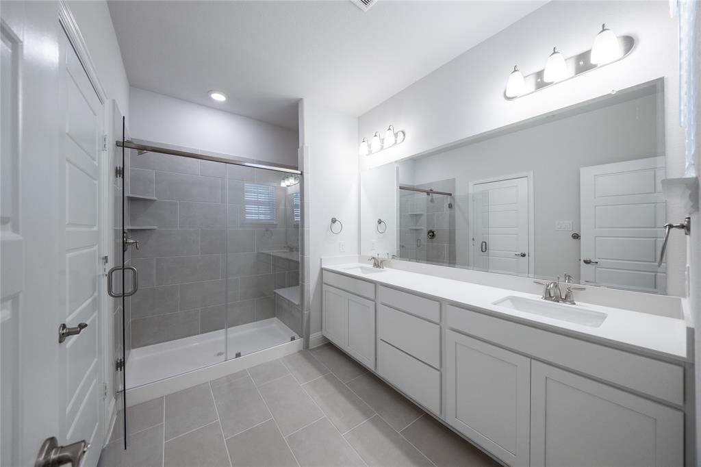 7929 Sunset Boulevard Rowlett, TX 75088 - Photo 10 of 32 a bathroom with a double vanity sink mirror double and shower
