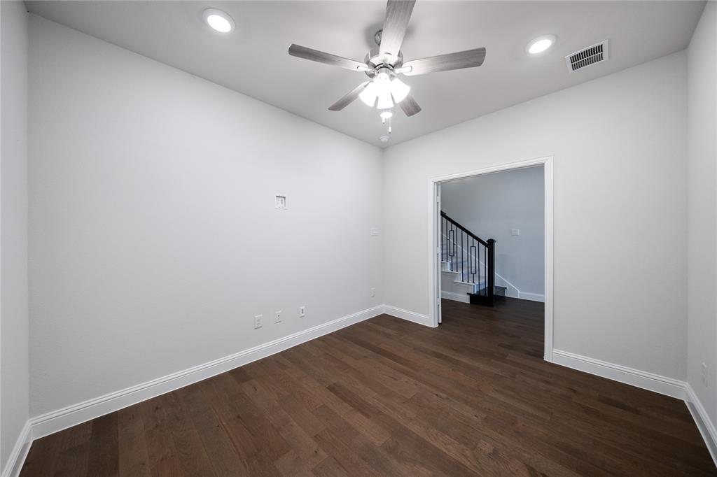 7929 Sunset Boulevard Rowlett, TX 75088 - Photo 16 of 32 an empty room with wooden floor and chandelier fan