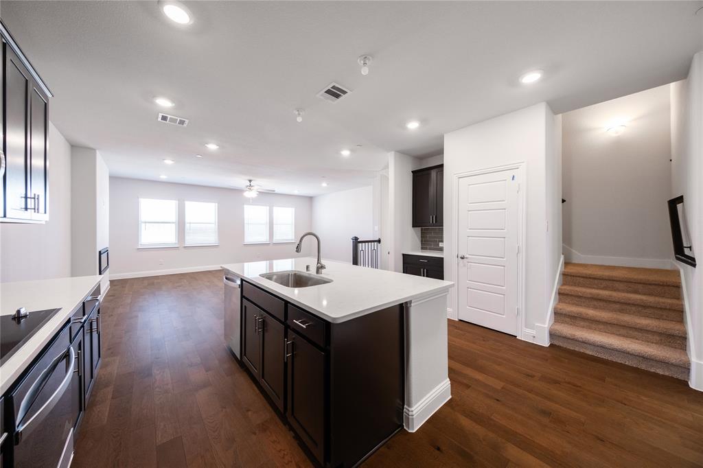 7929 Sunset Boulevard Rowlett, TX 75088 - Photo 3 of 32 a kitchen with a sink and wooden floor