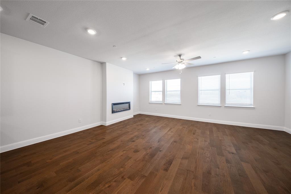 7929 Sunset Boulevard Rowlett, TX 75088 - Photo 4 of 32 an empty room with wooden floor and windows