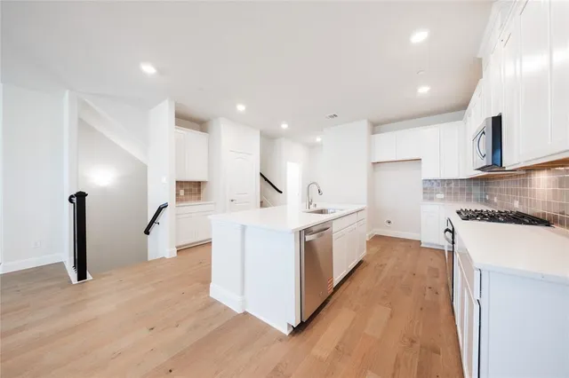 a kitchen with a sink stove and refrigerator