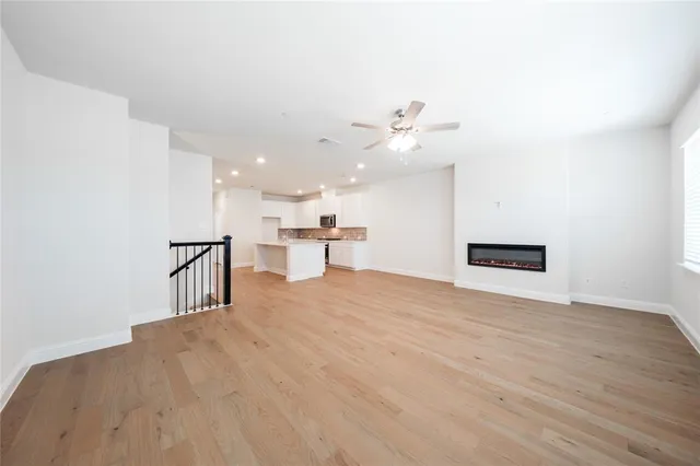 a view of an empty room with a kitchen