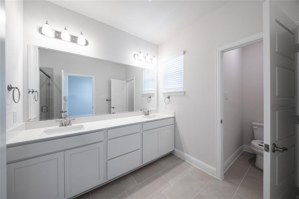 7929 Sunset Boulevard Rowlett, TX 75088 - Photo 9 of 32 a spacious bathroom with a double vanity sink mirror and double