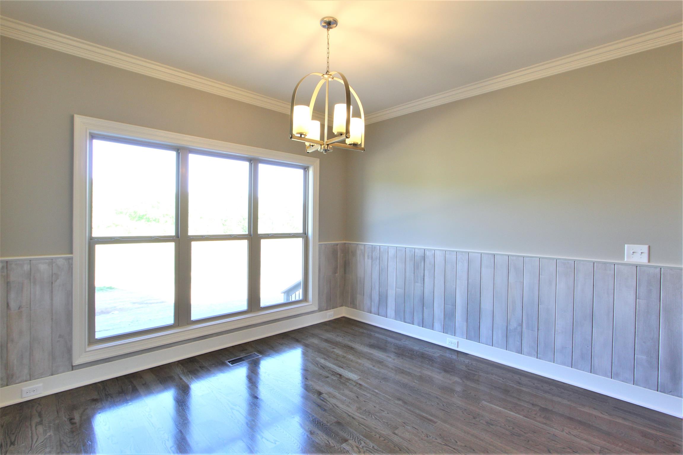 3818 Old Murfreesboro Road West, Unit 5 Lebanon, TN 37090 - Photo 12 of 27 a view of empty room with wooden floor and fan