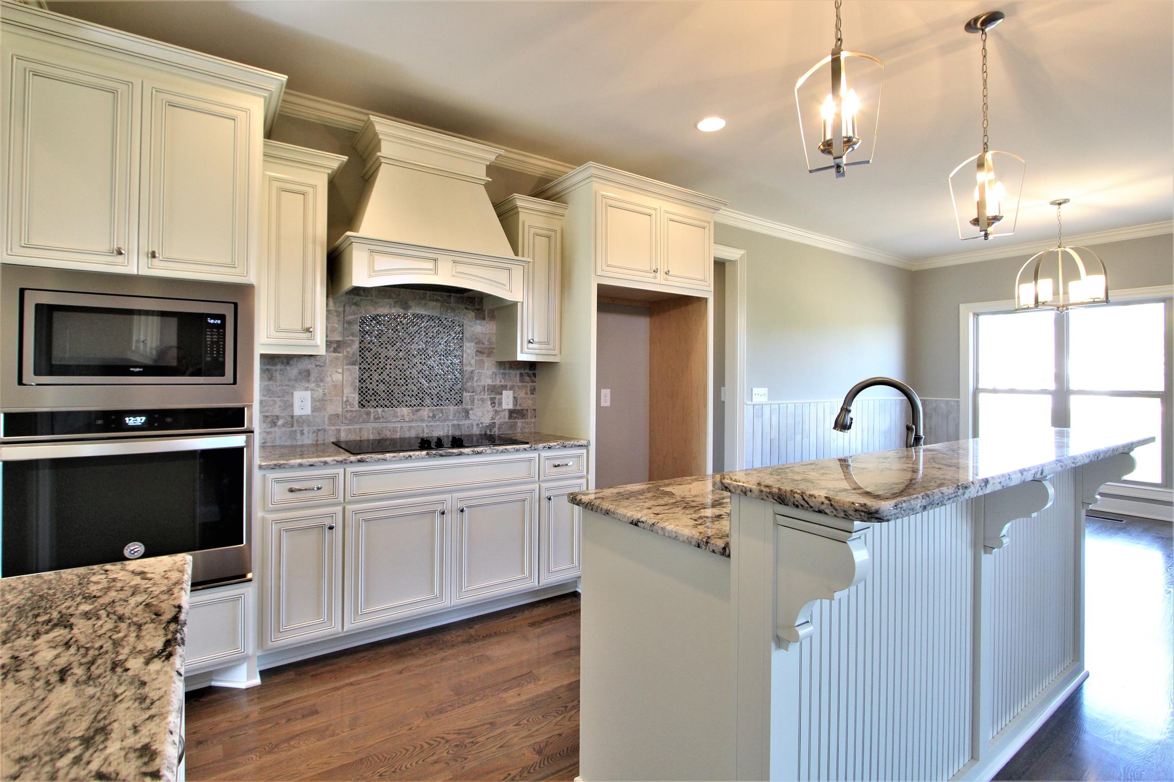 3818 Old Murfreesboro Road West, Unit 5 Lebanon, TN 37090 - Photo 14 of 27 a kitchen with stainless steel appliances granite countertop a stove a sink dishwasher and a refrigerator with wooden floor
