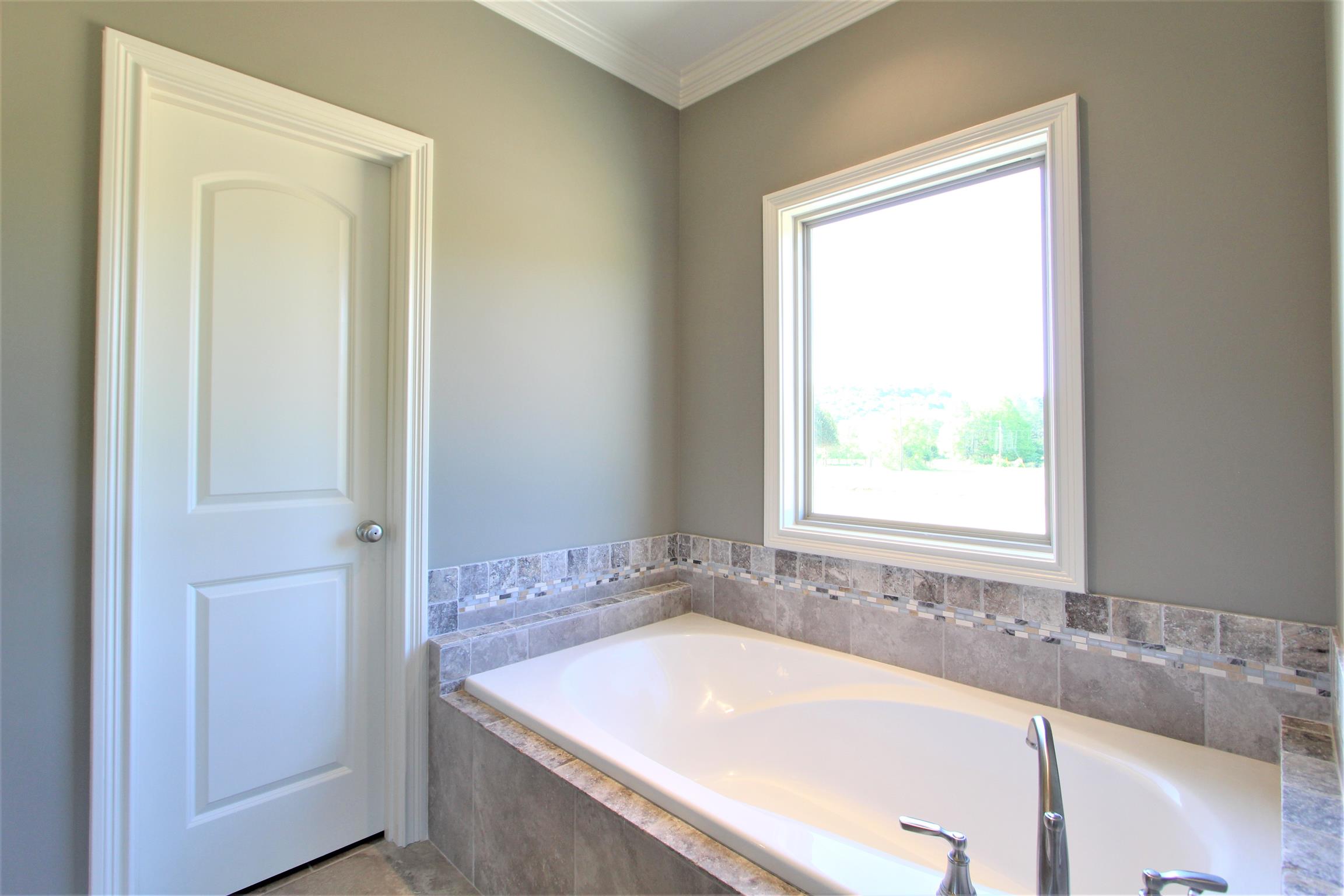 3818 Old Murfreesboro Road West, Unit 5 Lebanon, TN 37090 - Photo 20 of 27 a bath tub sitting in a bathroom next to a window