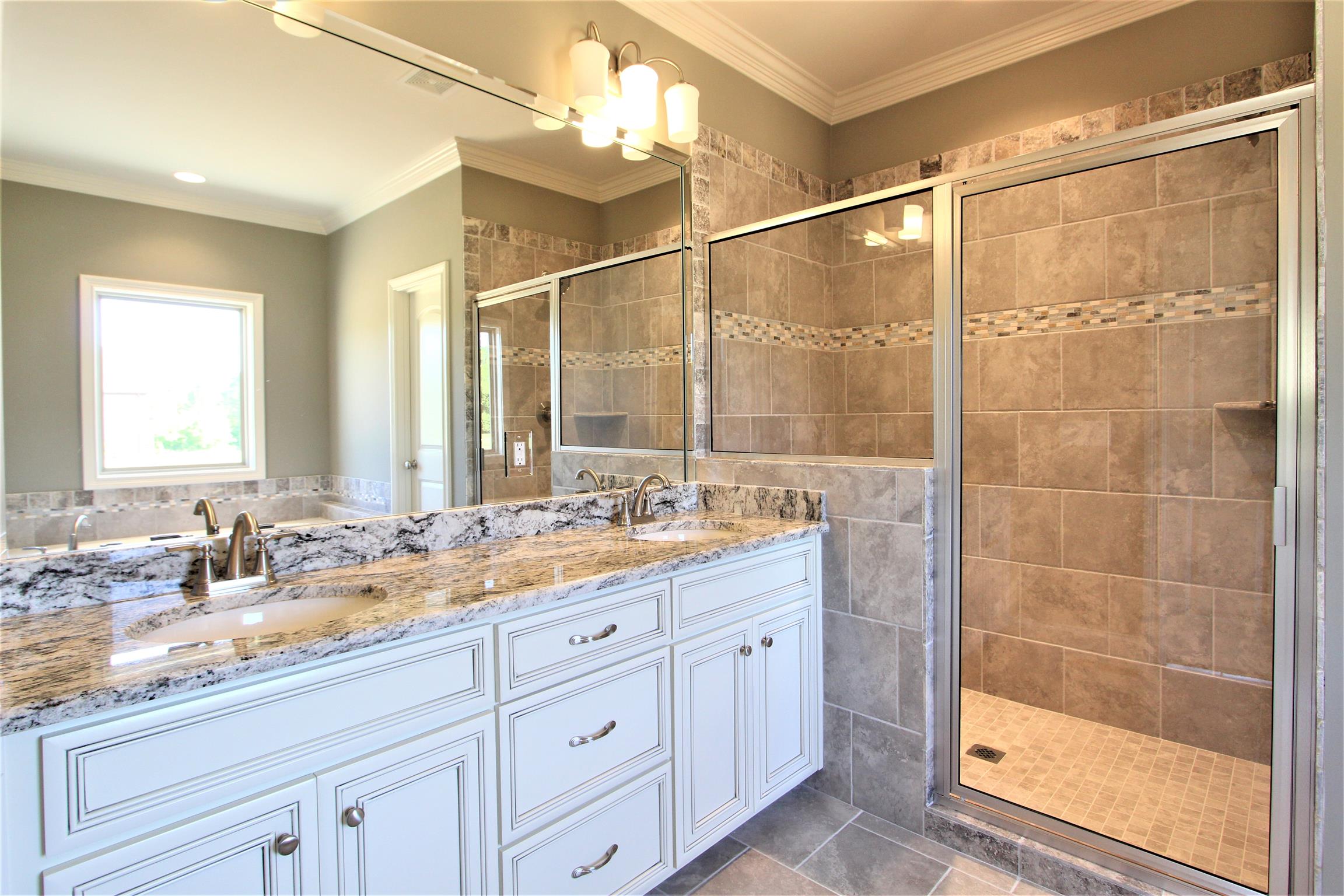 3818 Old Murfreesboro Road West, Unit 5 Lebanon, TN 37090 - Photo 21 of 27 a bathroom with a double vanity sink a mirror and a shower