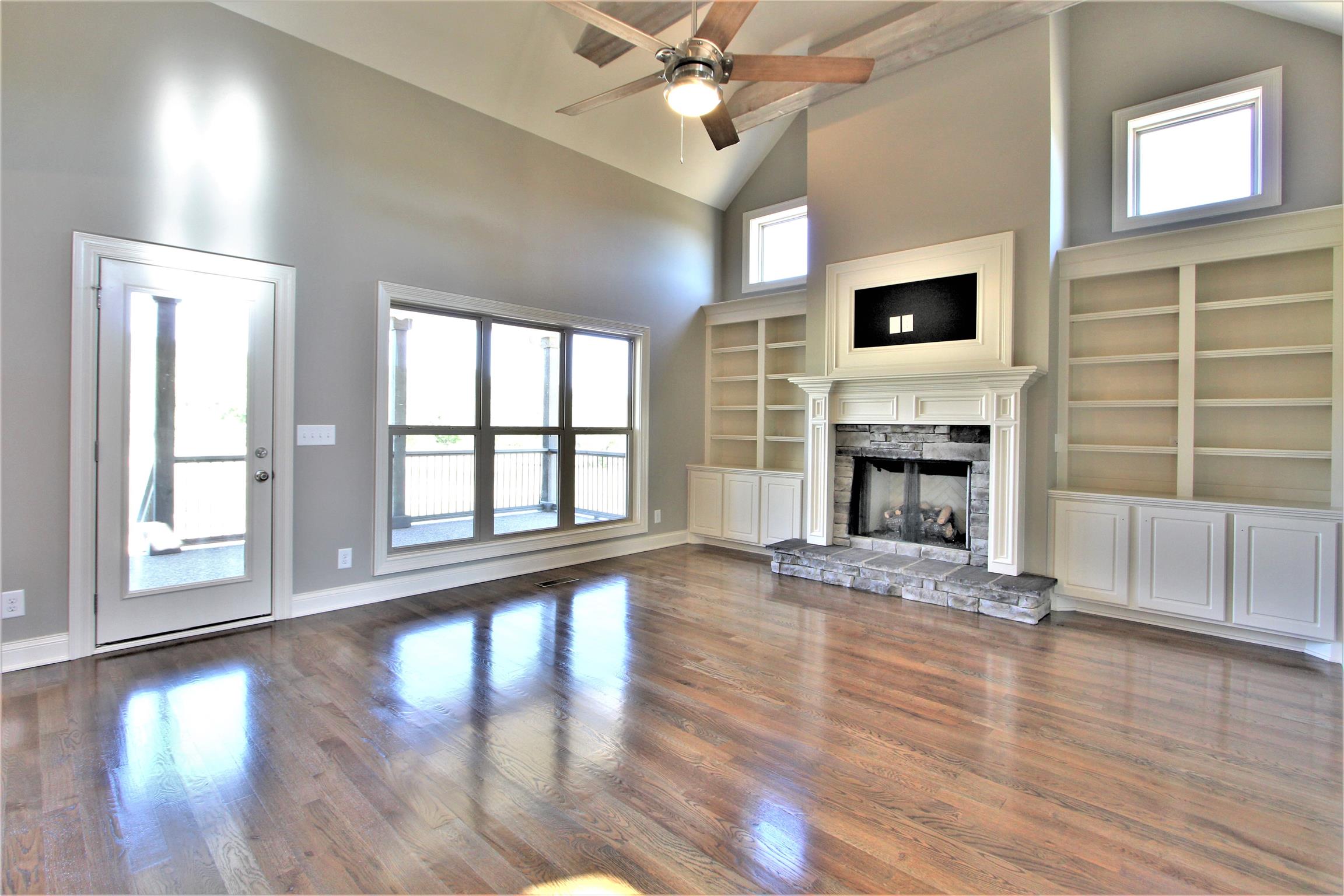 3818 Old Murfreesboro Road West, Unit 5 Lebanon, TN 37090 - Photo 7 of 27 an empty room with wooden floor fan and windows