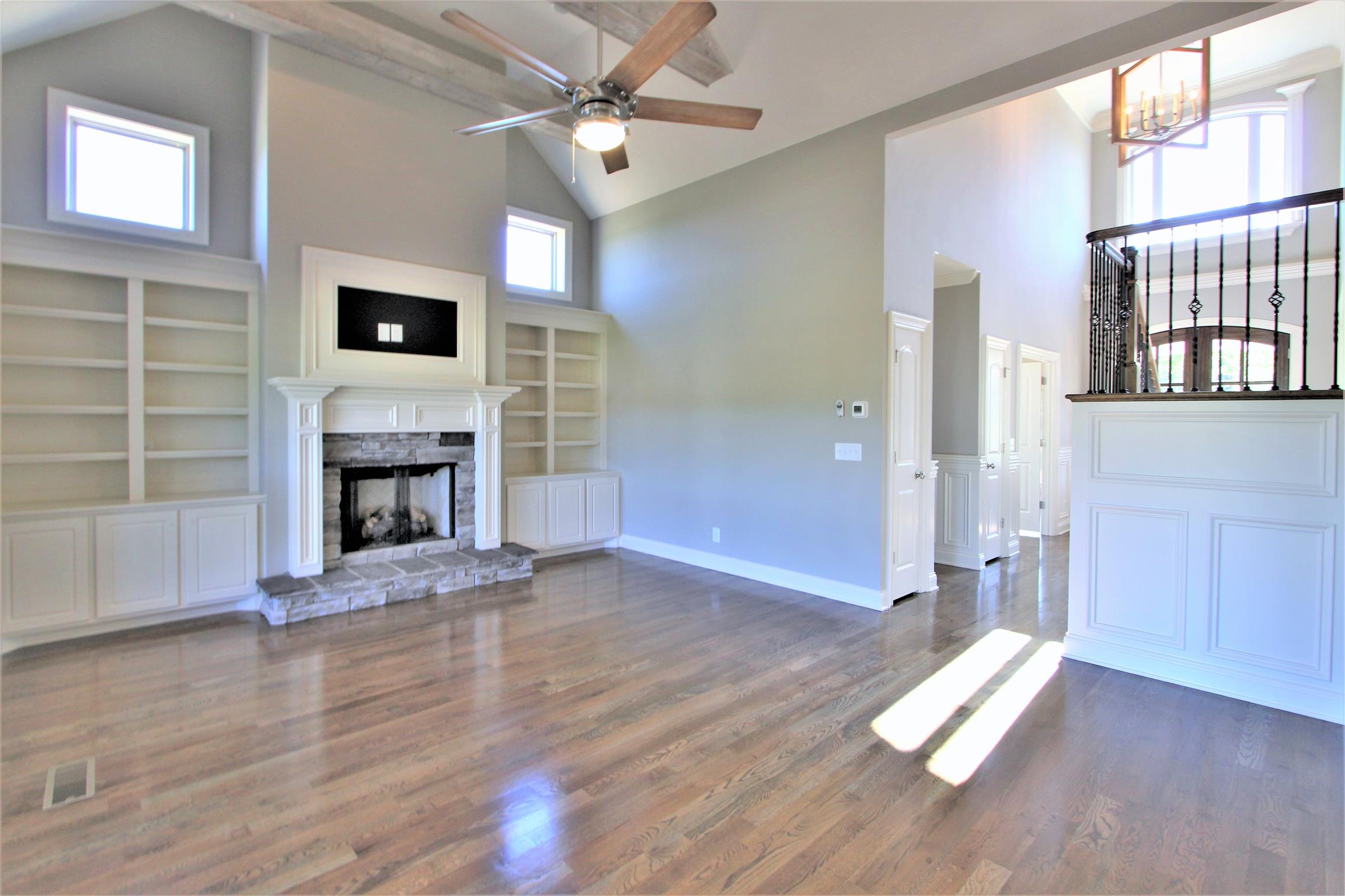 3818 Old Murfreesboro Road West, Unit 5 Lebanon, TN 37090 - Photo 8 of 27 wooden floor fireplace and windows in an empty room