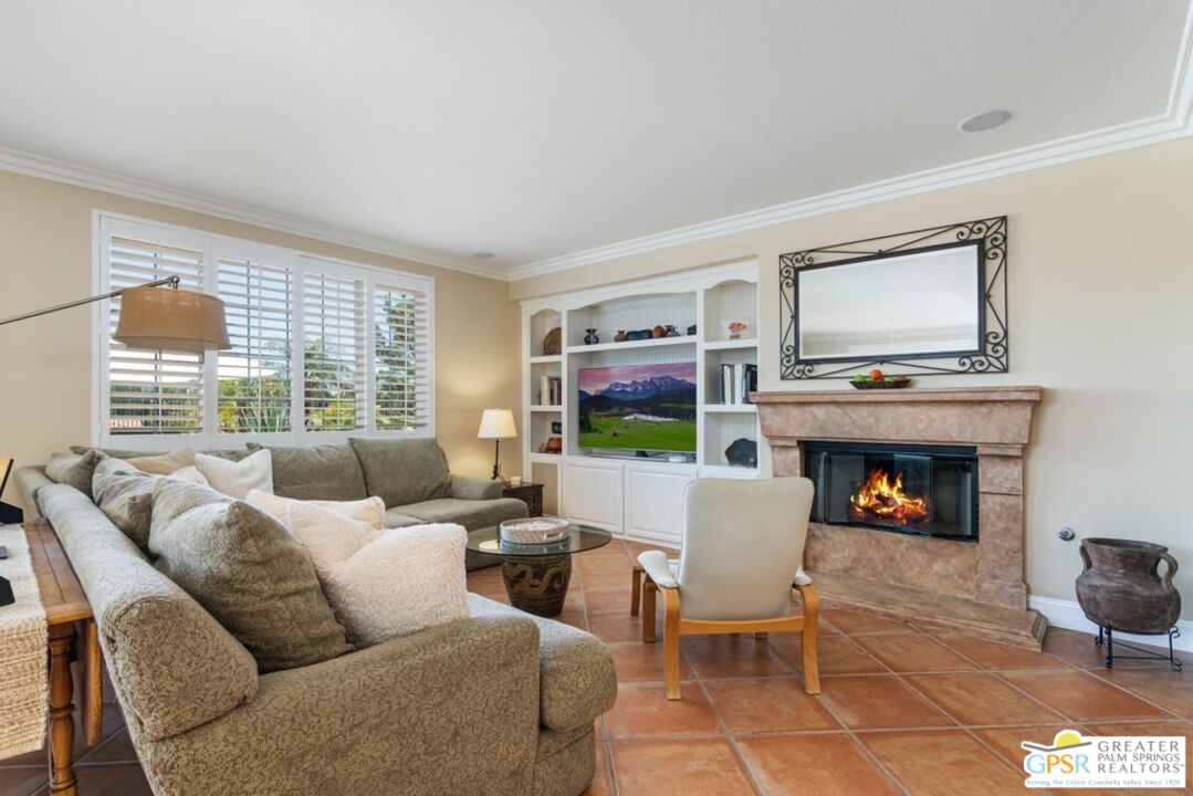45211 Willowick Street Temecula, CA 92592 - Photo 13 of 69 a living room with furniture a fireplace and a large window