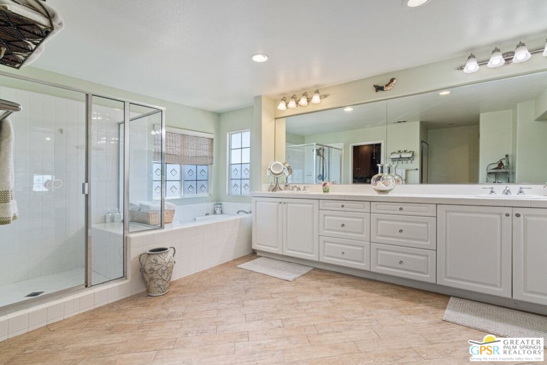 45211 Willowick Street Temecula, CA 92592 - Photo 28 of 69 a spacious bathroom with a granite countertop sink mirror and bathtub