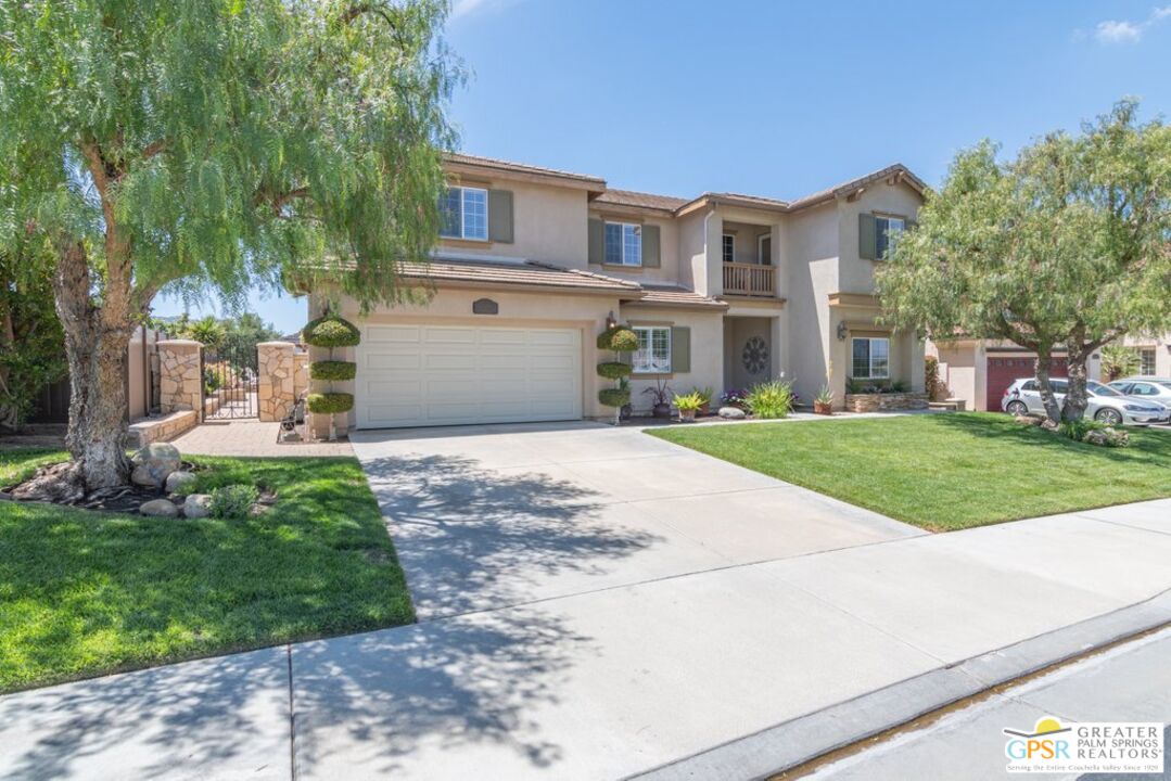 45211 Willowick Street Temecula, CA 92592 - Photo 3 of 69 a front view of a house with a yard and trees
