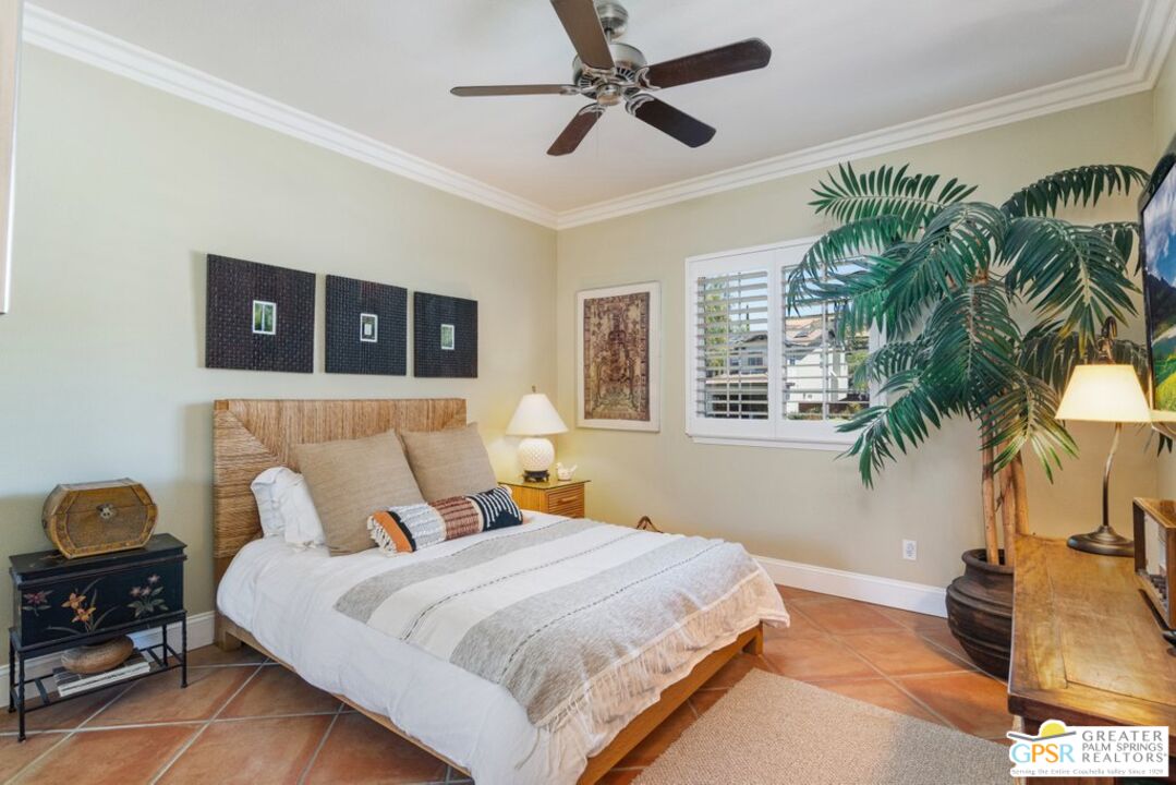 45211 Willowick Street Temecula, CA 92592 - Photo 31 of 69 a bedroom with a bed lamp and a potted plant