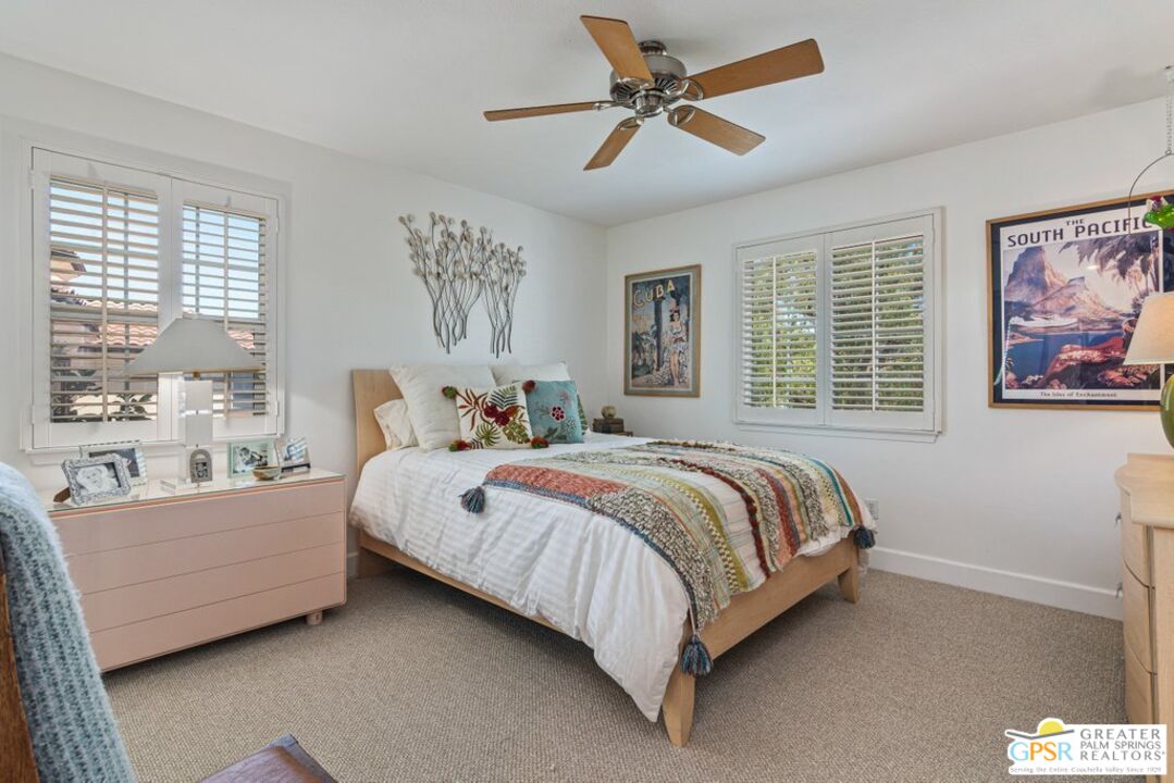 45211 Willowick Street Temecula, CA 92592 - Photo 35 of 69 a spacious bedroom with a bed a couch and a window