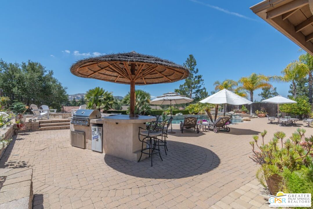 45211 Willowick Street Temecula, CA 92592 - Photo 48 of 69 a view of a patio with a table and chairs under an umbrella
