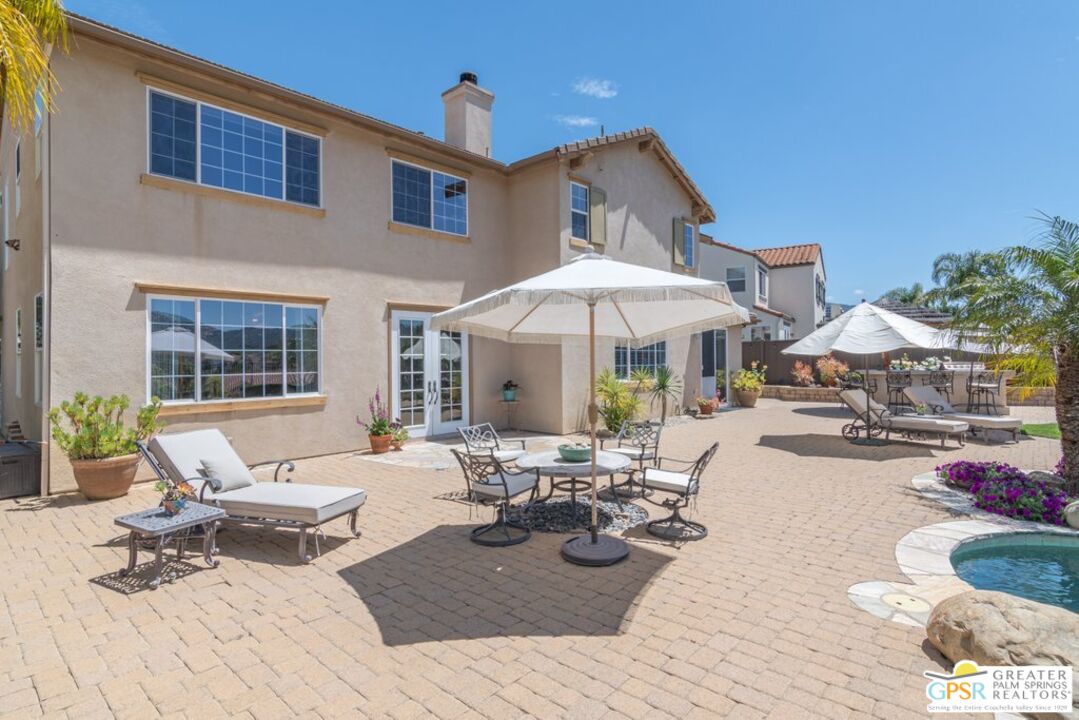 45211 Willowick Street Temecula, CA 92592 - Photo 58 of 69 a view of a patio with chairs and tables with umbrella