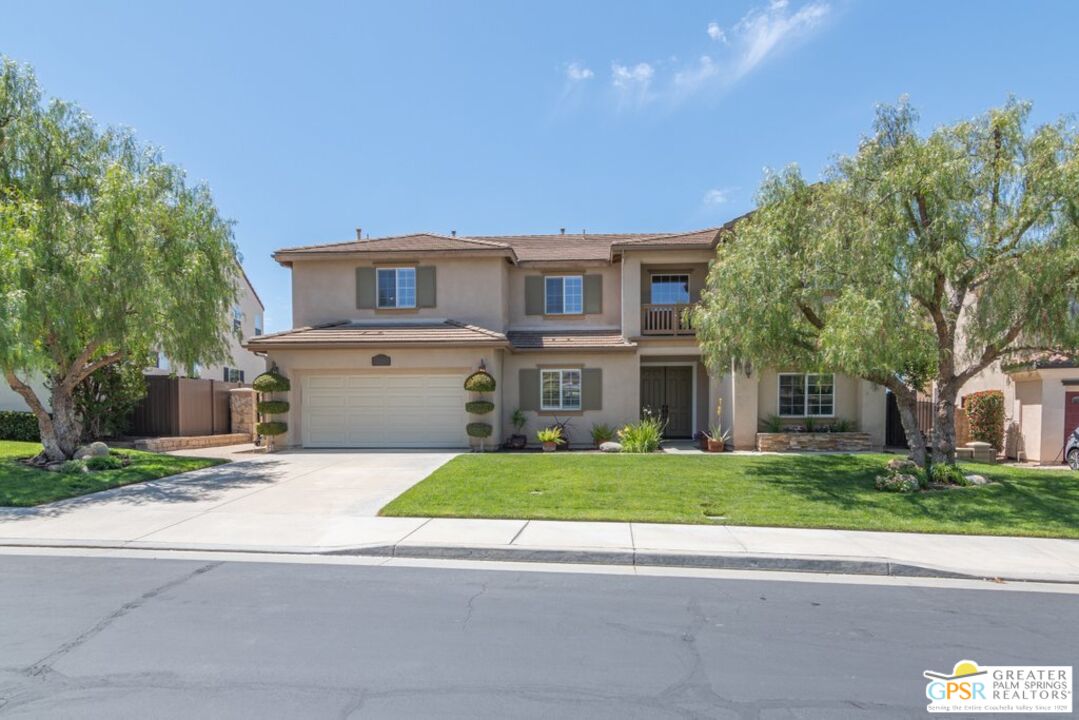 45211 Willowick Street Temecula, CA 92592 - Photo 60 of 69 a front view of a house with a yard and a garage